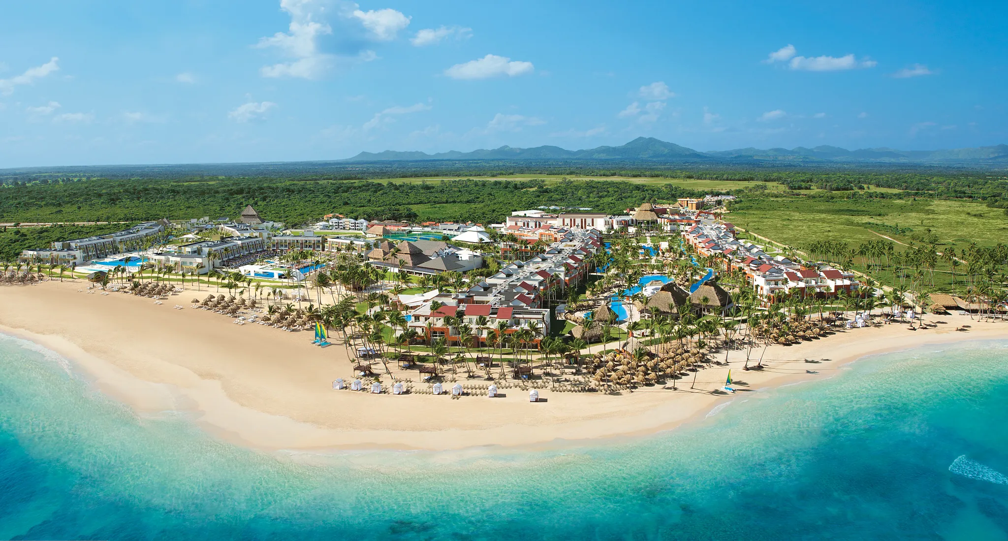 Aerial view of Breathless Punta Cana Resort showcasing beachfront pools, tropical grounds, and modern architecture.