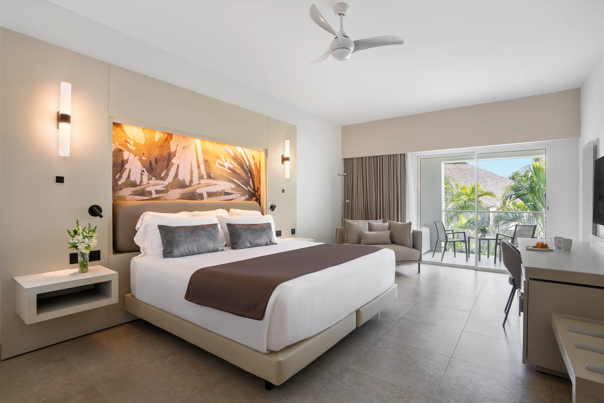 Allure Junior Suite with king bed and private balcony overlooking lush tropical gardens at Breathless Punta Cana Resort.
