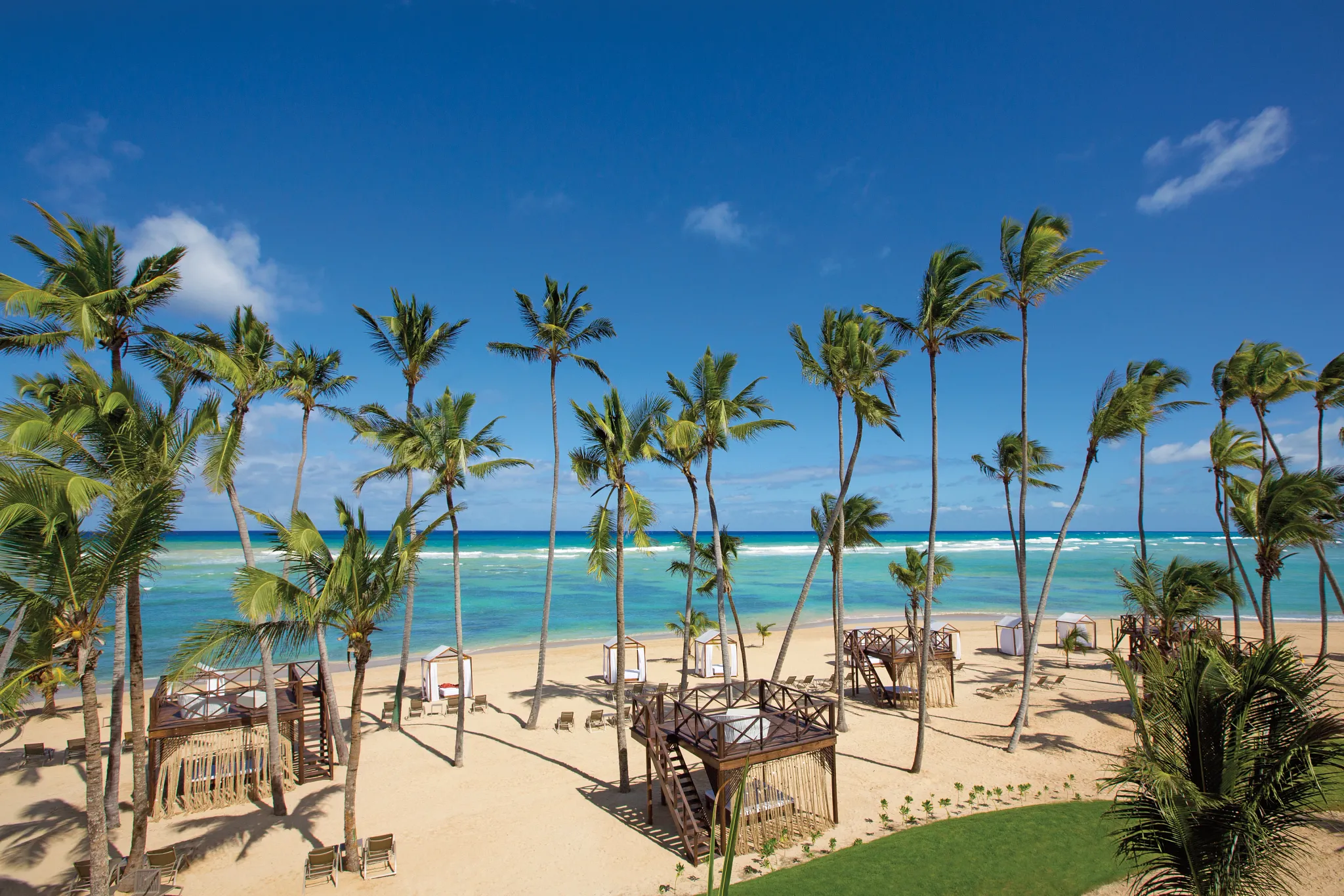 Wide panoramic view of the beach at Breathless Punta Cana with cabanas and ocean horizon.