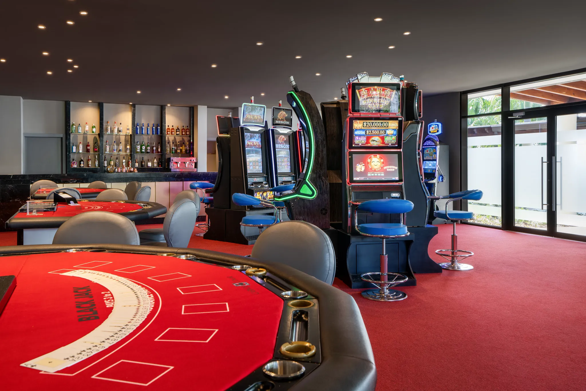 Interior view of the casino at Breathless Punta Cana featuring gaming tables and slot machines.