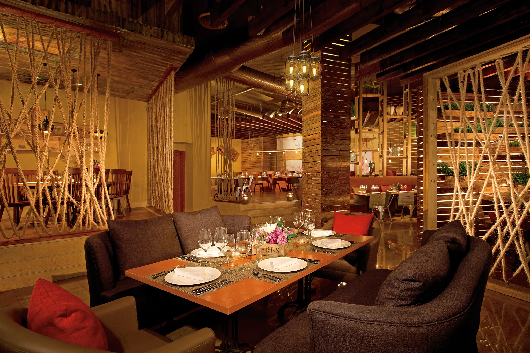 Culinaria international specialties restaurant at Breathless Punta Cana featuring rustic-chic décor, elegant table settings, and a warm, inviting dining atmosphere.