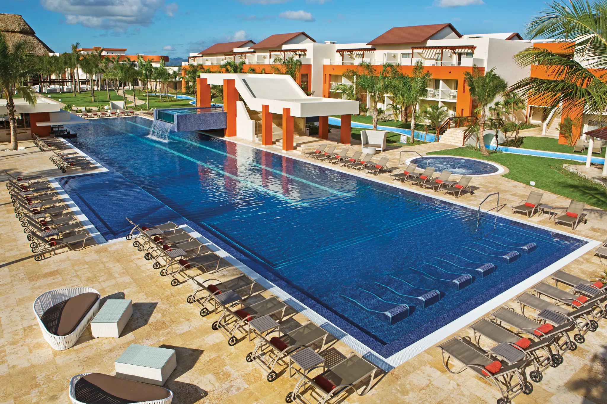 Freestyle pool area at Breathless Punta Cana with lounge chairs, palm trees, and modern pool design.