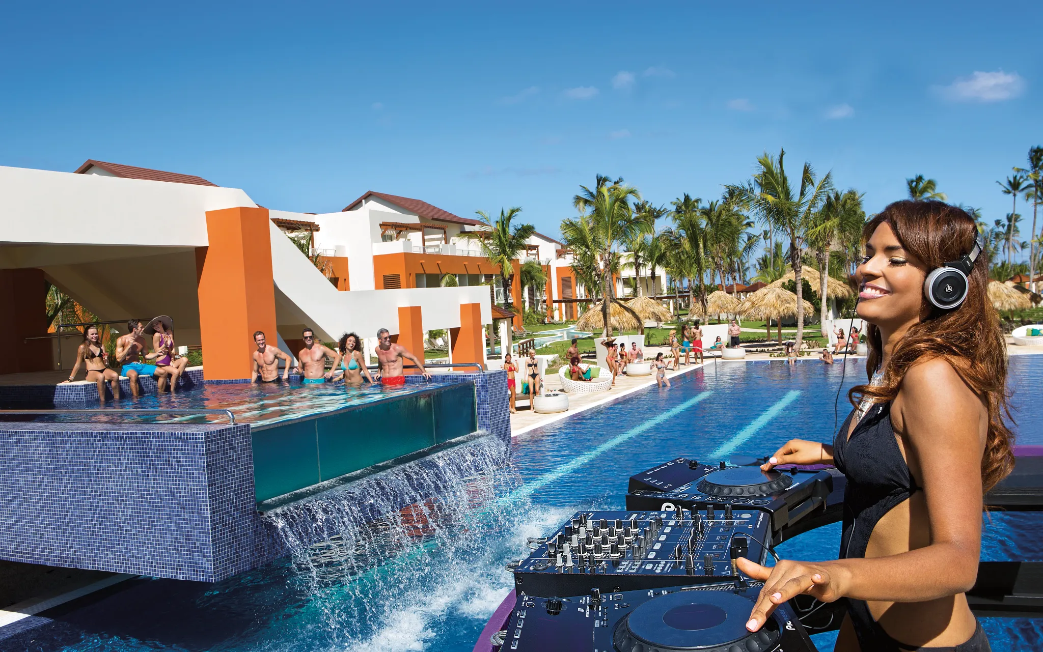 Freestyle Swim & Entertainment Zone swim-up bar at Breathless Punta Cana featuring live DJ entertainment, infinity pool views, and a lively pool party atmosphere.