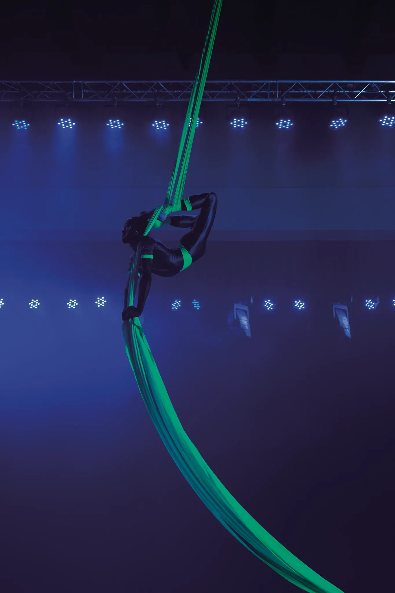 Aerial performance during a live night show at Breathless Punta Cana under stage lighting.