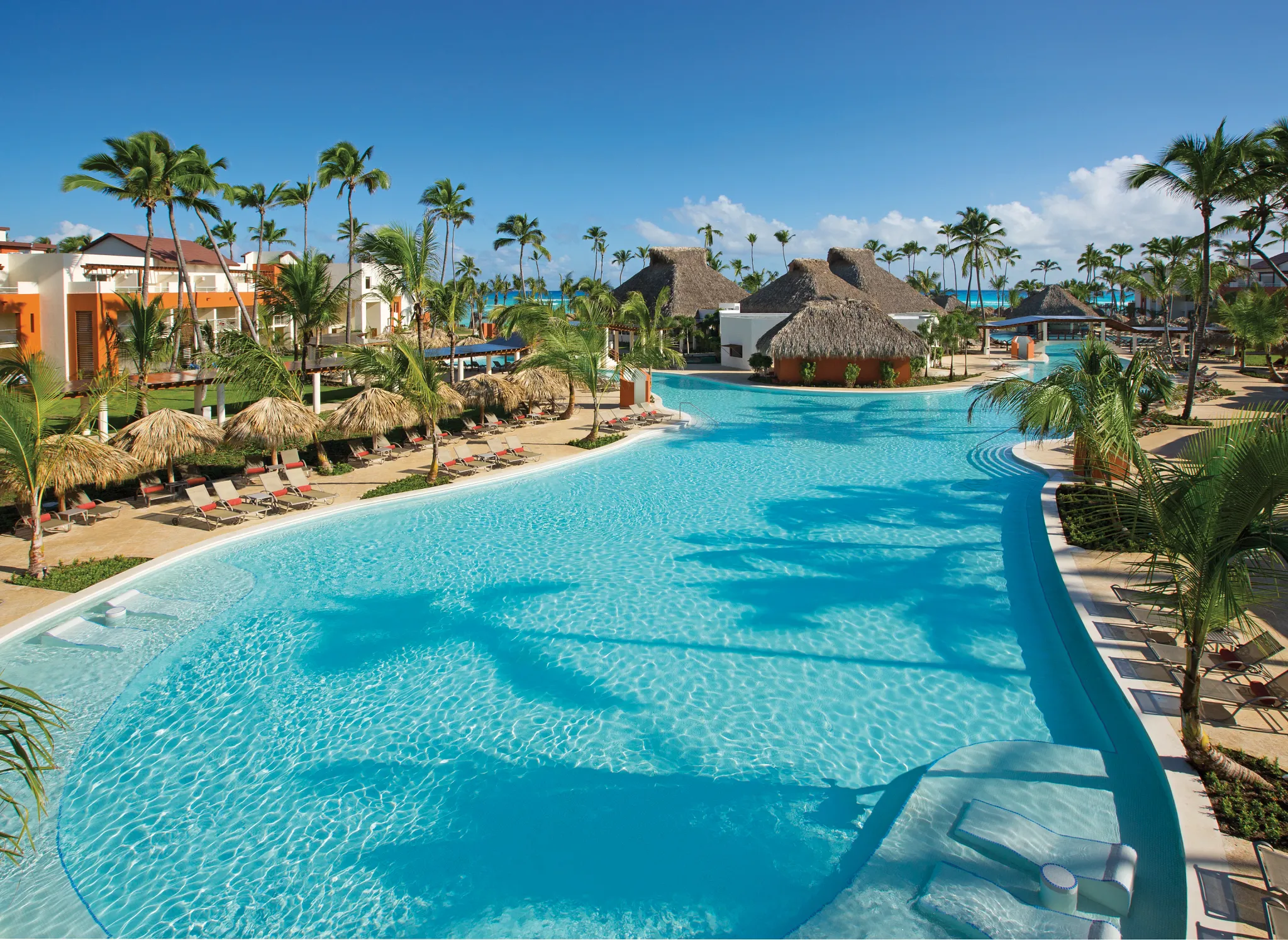 Main pool at Breathless Punta Cana featuring expansive swimming areas and surrounding resort buildings.