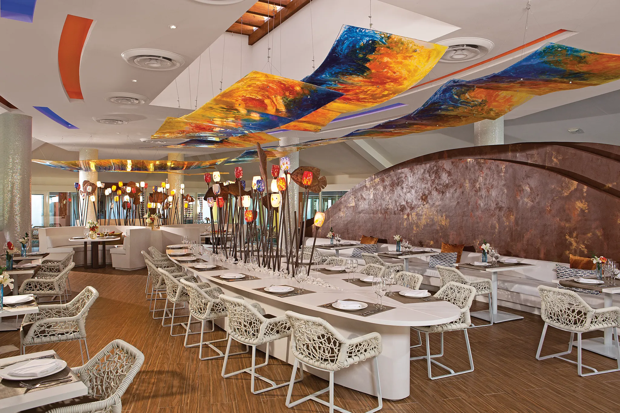 Spumante Italian restaurant at Breathless Punta Cana featuring modern dining tables, artistic ceiling décor, and an elegant upscale atmosphere.