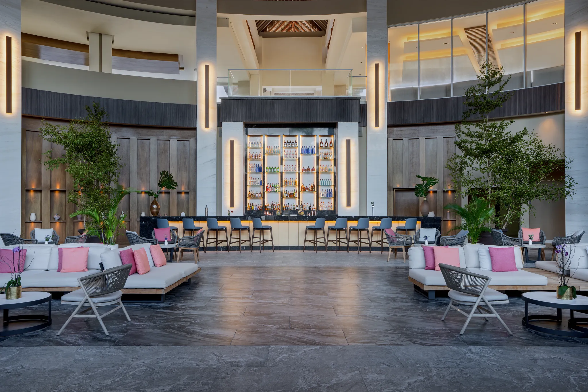 Wink lobby cocktail bar at Breathless Punta Cana featuring a stylish lounge area, illuminated bar display, and modern resort ambiance.